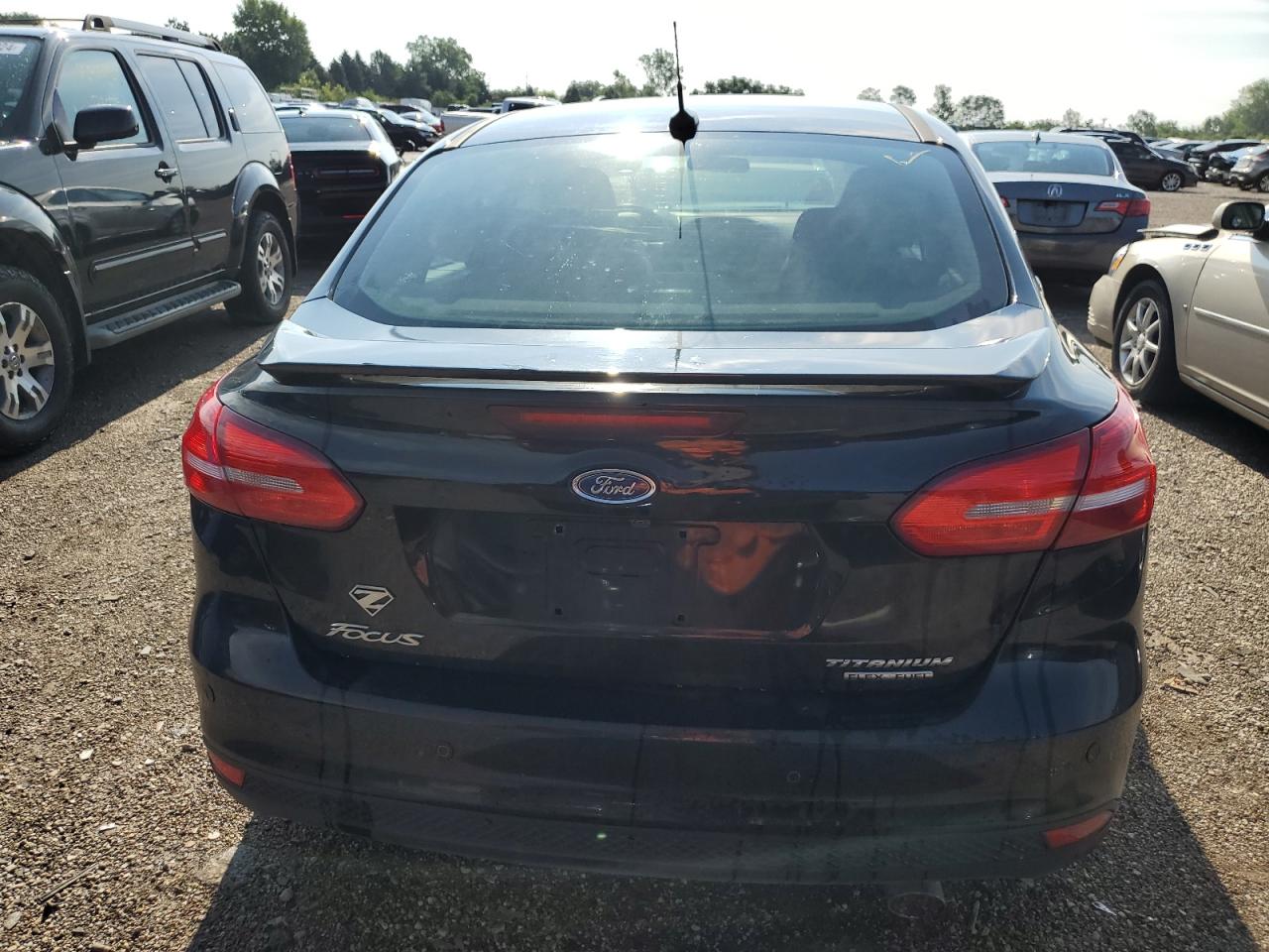 2016 Ford Focus Titanium VIN: 1FADP3J27GL297328 Lot: 62425424