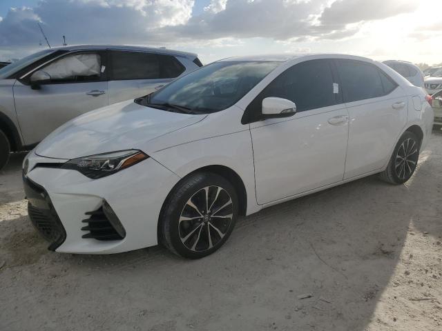 VIN 5YFBURHE2JP824509 2018 Toyota Corolla, L no.1